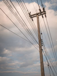 Low angle view of electricity pylon against sky