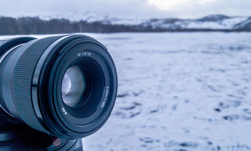 Close-up of camera against the sky