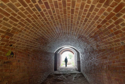 Man walking in tunnel