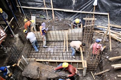 High angle view of people working at construction site - colado cemento
