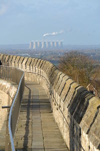 The city wall with the power station in the distance