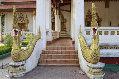 Statues on staircase outside building