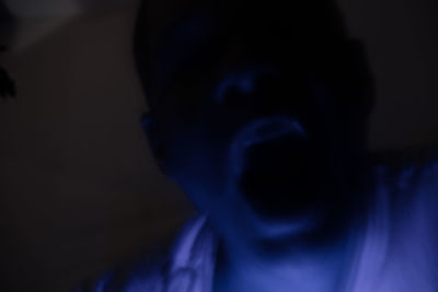 Close-up of man against black background