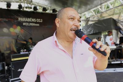 Full length of man holding camera while standing outdoors