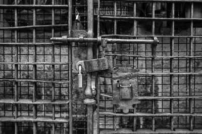 Close-up of old metal railing against wall