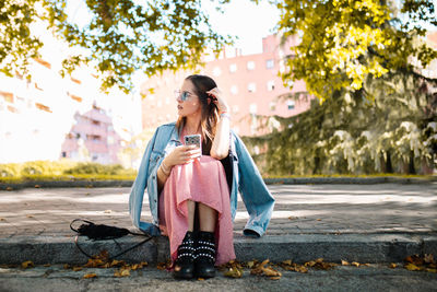 Full length of woman sitting in park