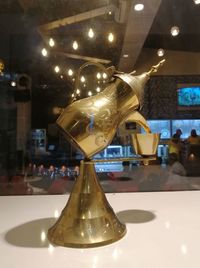 Close-up of illuminated glass table at restaurant