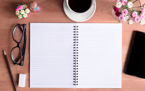Directly above shot of book and coffee on table