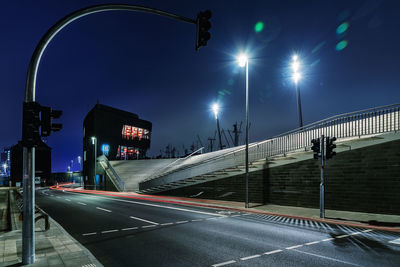 Light trails on road against sky at night