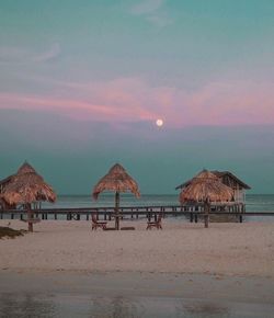 Scenic view of beach against sky during sunset