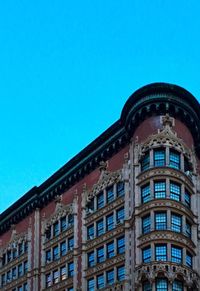 Low angle view of residential building against clear blue sky