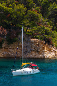 Sailboat at the coast near patitiri village on alonissos island.