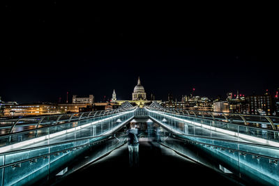 Illuminated bridge and buildings at night