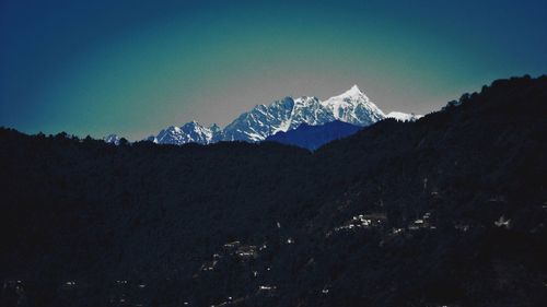 Scenic view of mountains against clear blue sky