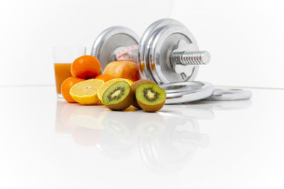 Close-up of orange fruits on white surface