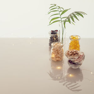 Close-up of glasses on table against white background