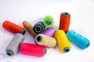 High angle view of multi colored pencils against white background