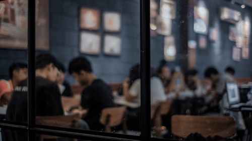 Group of people looking through window