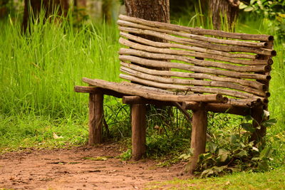 Wooden bench on field in park