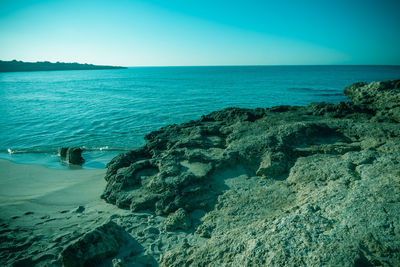 Scenic view of sea against clear blue sky