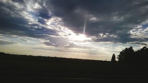 Silhouette of landscape against cloudy sky