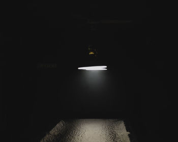 Illuminated lamp in building at night