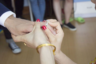 Midsection of couple holding hands