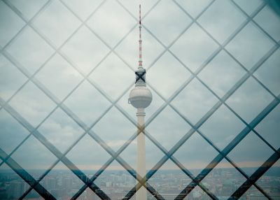 Low angle view of tower and building against sky