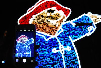 Close-up of christmas decorations against black background