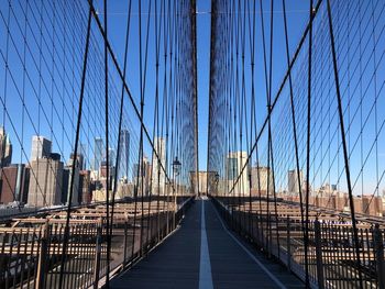 View of suspension bridge against clear blue sky