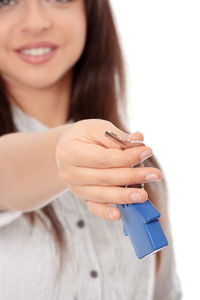 Close-up of woman holding hands over white background