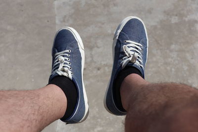 Low section of man wearing shoes