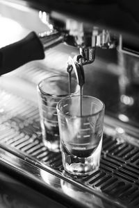 Close-up of coffee pouring in glass