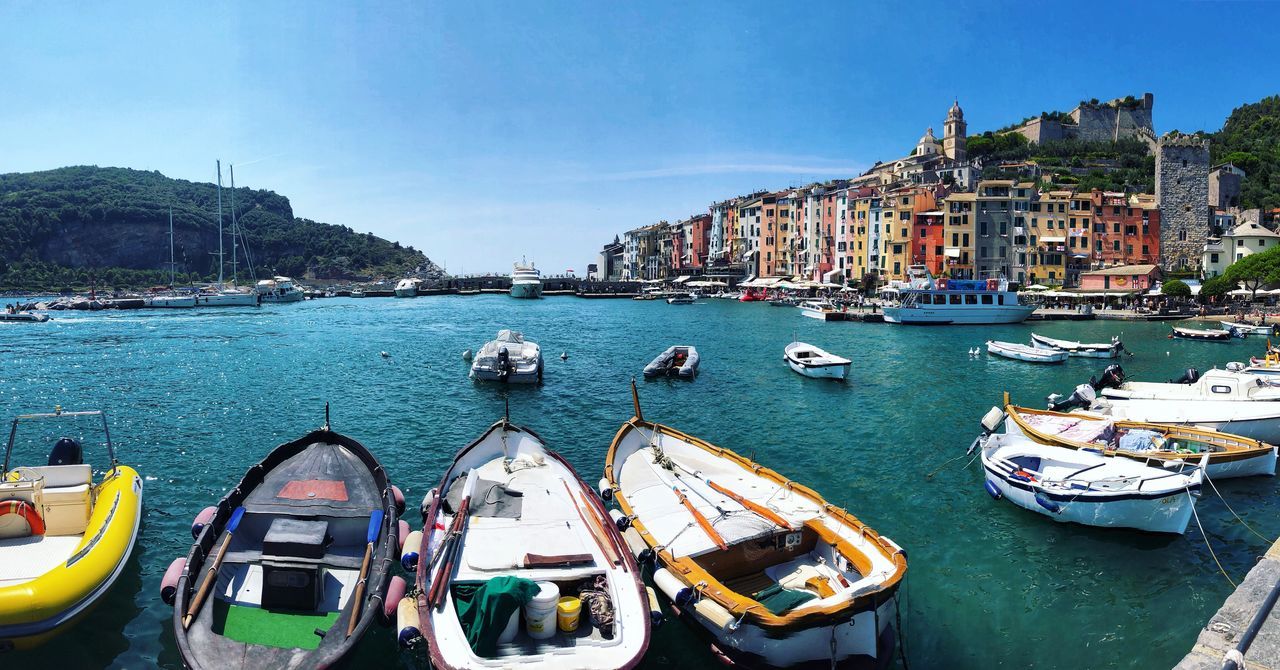 nautical vessel, water, transportation, mode of transportation, building exterior, sky, architecture, nature, city, day, built structure, sea, moored, building, no people, mountain, travel, harbor, travel destinations, outdoors, sailboat, bay