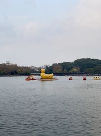 Boat sailing on river against sky