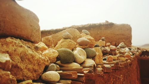 Stack of pebbles on beach against clear sky