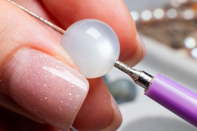 Close-up of hand holding sewing needle