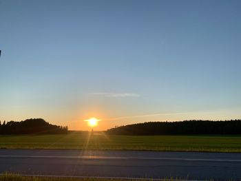 Scenic view of field against sky during sunset