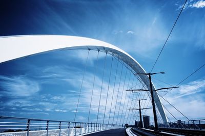 Low angle view of suspension bridge against sky