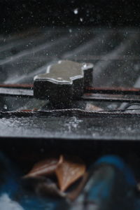 Close-up of snow covered car window at night