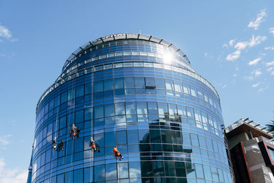 Low angle view of modern building against blue sky