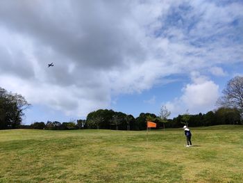 Full length of a young boy , playing golf