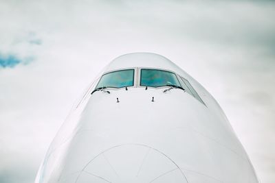 Close-up of airplane against sky