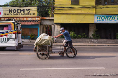 Man riding bicycle on road