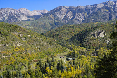 Ranch in a valley surrounded by mountains and fall color