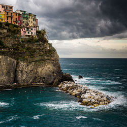 Dramatic storm clouds rolling in over manarola, cinqeterre, italy.