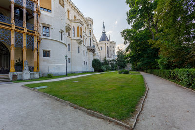 Footpath amidst buildings against sky