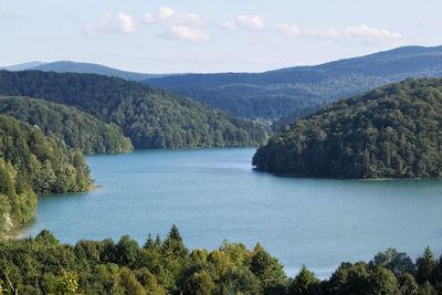 Scenic view of lake and mountains against sky