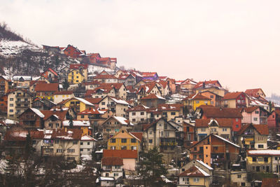 Houses in town against clear sky