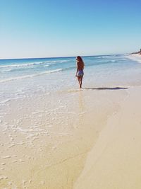 Scenic view of beach against blue sky